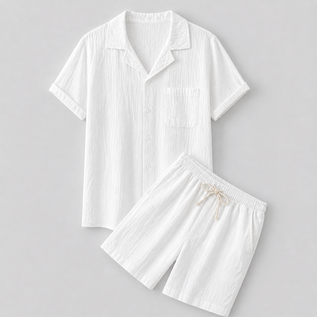 White linen shirt and shorts set on a gray background
