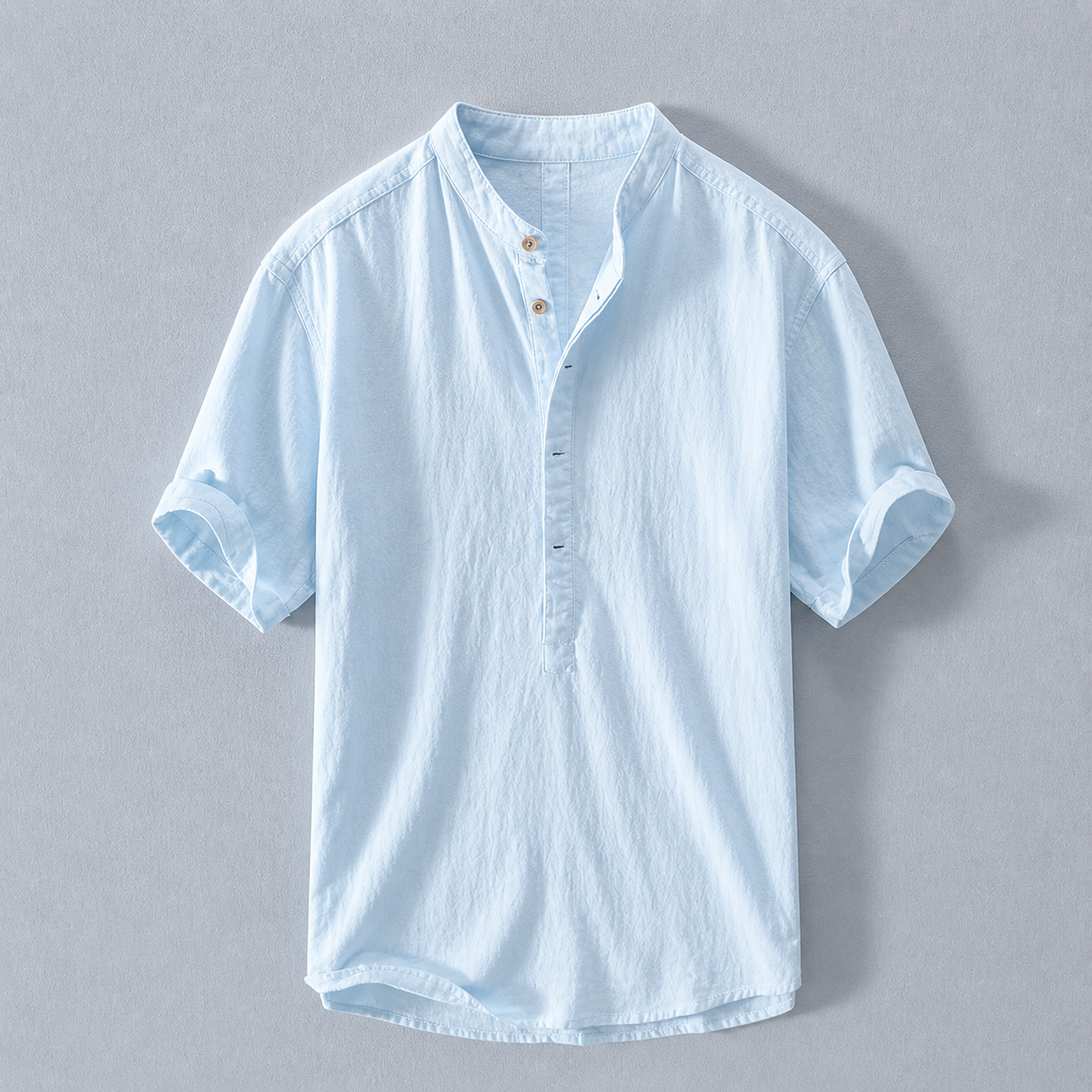 Light blue short-sleeve shirt on a gray background
