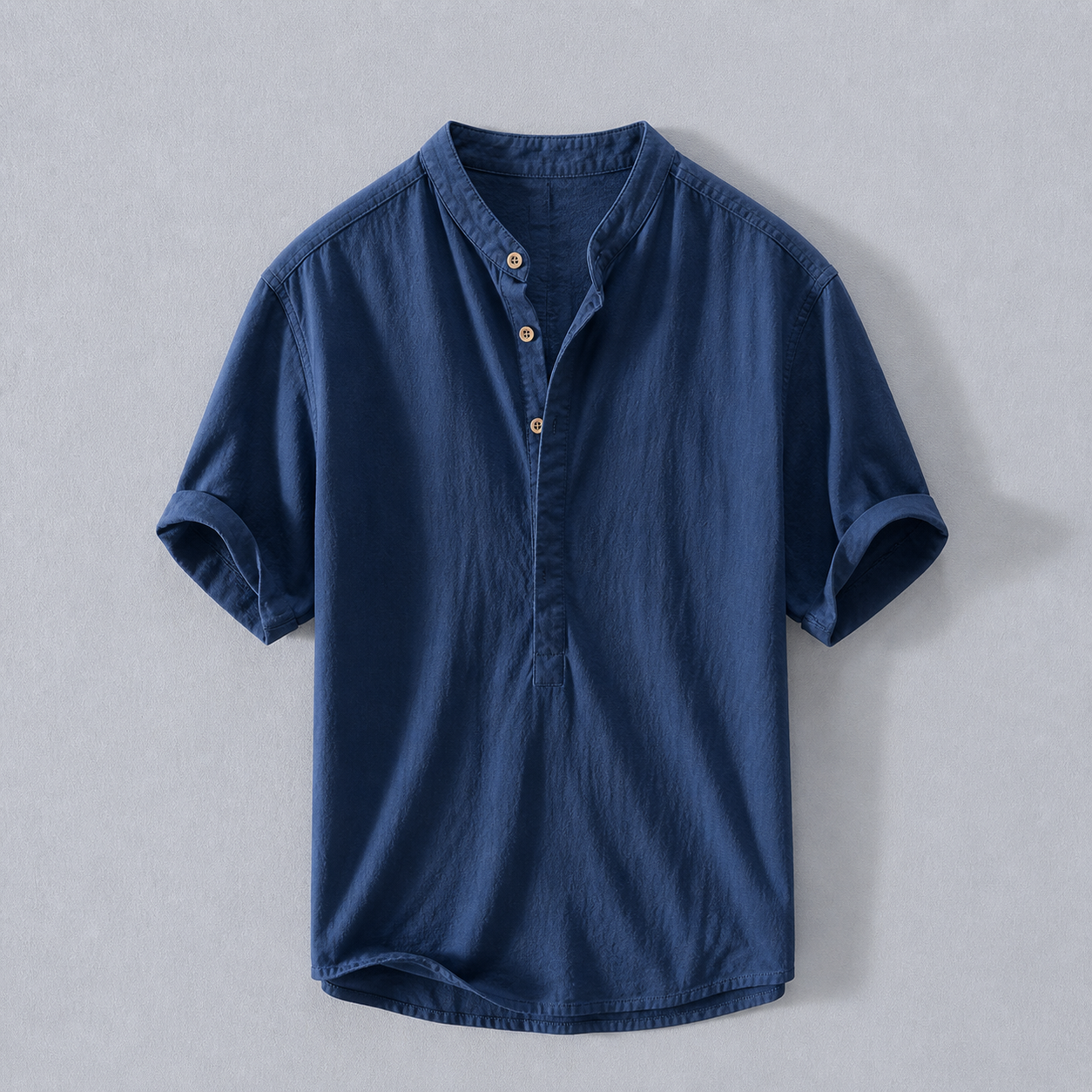 Blue short-sleeve shirt on a light gray background
