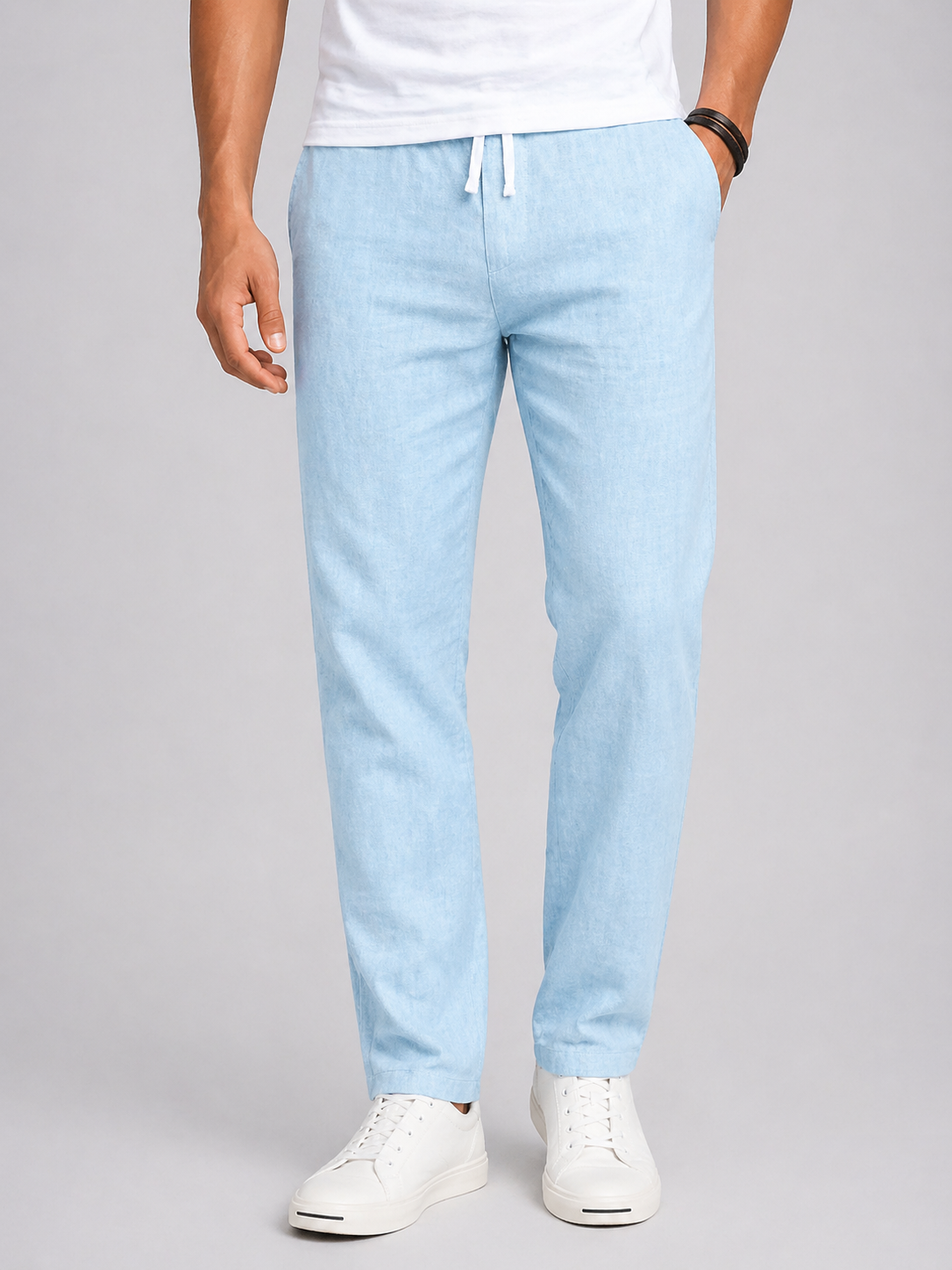 Light blue pants worn by a person on a gray background