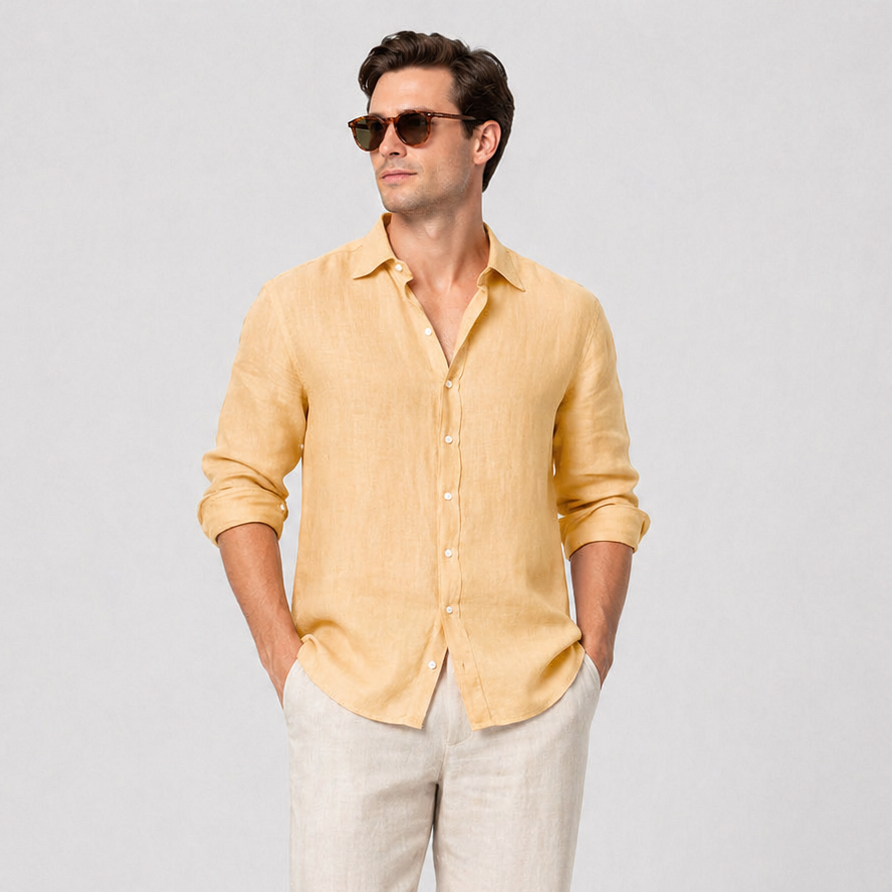 Men's mustard yellow linen long sleeve button-up shirt with rolled sleeves, paired with light beige linen trousers.