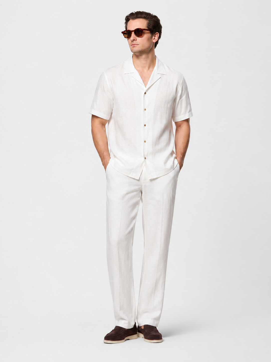 Men's white linen two-piece set: short-sleeve button-up shirt with open collar and straight-leg pants.