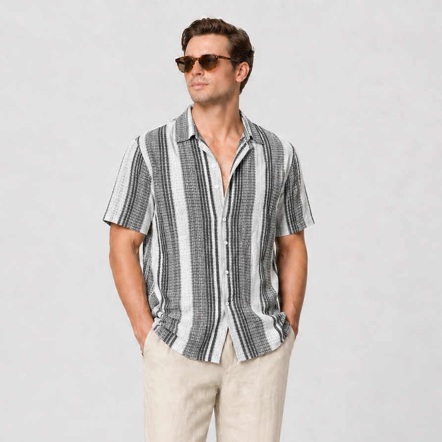 Men's short-sleeve striped shirt with turn-down collar, paired with beige trousers and brown loafers.