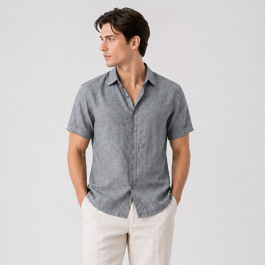 Men's classic grey short sleeve button-up shirt with a pointed collar, paired with light beige linen trousers.
