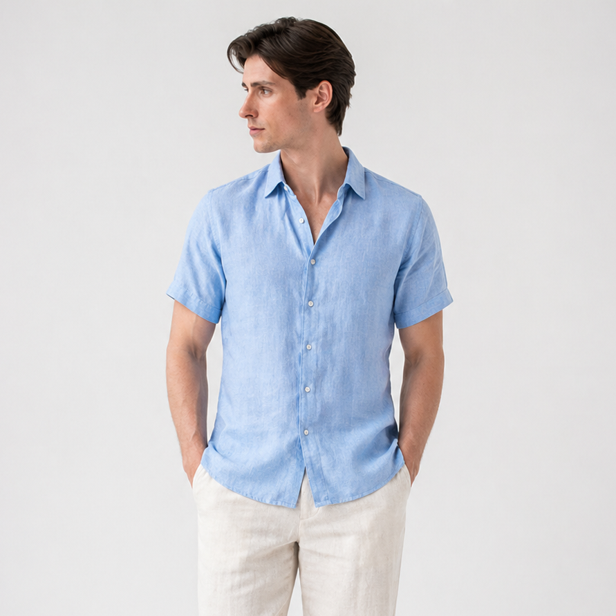 Men's classic light blue short sleeve button-up shirt with a pointed collar, paired with beige linen pants.