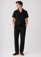 Man wearing a black outfit with a white background